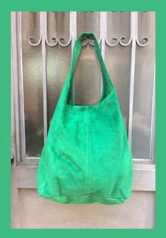 LARGE slouch leather bag in GREEN . Leather tote bag. Natural genuine SUEDE leather. NOT LINED. We added a small leather zipper pouch for your mobile phone and/or cards or money. It ist attached to the inside of the bag by a metal chain. This listing is for the bag in bright GREEN , there is a separate listing in our shop for moss green and also for the dark green bag on the last picture with the model. The bag is closed by a metal clip at the center. Width : 42cm - 16,5 in Height at the center: Green Leather Hobo Bag With Large Capacity, Green Leather Hobo Shoulder Bag, Green Leather Tote Hobo Bag, Green Leather Hobo Tote Bag, Suede Lined Hobo Tote Bag For Shopping, Green Leather-handled Hobo Satchel Bag, Green Double Handle Hobo Bag For Shopping, Green Hobo Bag With Leather Handles For Daily Use, Green Tote Hobo Bag For Shopping