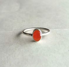 Pure carnelian Ring, 925 Sterling Silver Ring, Carnelian Jewelry , Handmade Ring , Carnelian Ring , Birthstone Jewelry, Proposal Ring. Details Handmade item Delivery from a small business in India Materials: Silver, Stone Gemstone: Onyx Gem colour: Orange Band colour: Silver Style: Art deco Recycled Made to Order Description Stone Name - Natural Carnelian Cabochon Cut Grade - Smooth Quality - AA- AAA Metal - 925 Sterling Silver Payment Policy We accept payment through PayPal Payment should be ma Oval Carnelian Orange Ring, Oval Orange Carnelian Rings, Orange Oval Carnelian Rings, Carnelian Orange Rings For Gifts, Orange Carnelian Rings For Gifts, Orange Carnelian Oval Cabochon Jewelry, Orange Carnelian Ring Jewelry, Handmade Orange Carnelian Rings, Carnelian Gemstone Rings In Oval Cabochon Shape