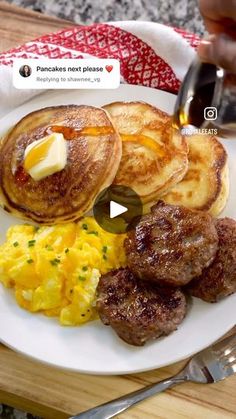 a plate with pancakes, eggs and sausage on it