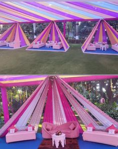 the inside of a tent decorated with pink and yellow fabric, white tables and couches