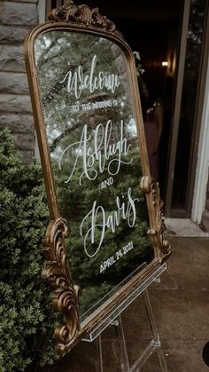 a sign that says welcome to the bride and groom in front of a brick building