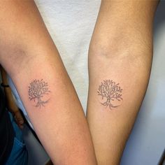 two people with matching tattoos on their arms