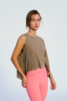 Turn up the tempo in this featherlight tank, with a sweat-wicking finish and a relaxed silhouette that brings a breath of fresh air to your every move. **Fit:** Relaxed fit; arced hem with deep side slits, crew neck **Features:** Airy, sweat-wicking fabrication, four-way stretch fabric that moves with you, relaxed silhouette **Why We ❤ It:** Easy to lounge in, easy to move in, this top keeps you cool and comfortable all day long. | Tempo Tank Top by FP Movement at Free People, Dried Thyme, XS Summer Yoga Muscle Tee With Relaxed Fit, Spring Yoga Tank Top With Relaxed Fit, Relaxed Fit Sleeveless Tank Top For Yoga, Go-dry Tops For Gym And Summer, Go-dry Tops For Gym In Summer, Summer Gym Tops With Go-dry Technology, Functional Summer Muscle Tank Tee, Functional Muscle Tank Tee For Summer, Versatile Sports Tops For Summer