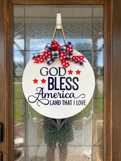 a sign that says god bless america land that i love hanging on the front door