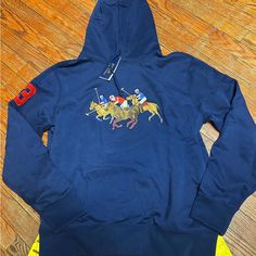 Ralph Lauren Blue Cotton Hoodie With Embroidered Logo, Blue Fleece Tops With Embroidered Logo, Blue Winter Hoodie With Logo Detail, Blue Hooded Sweatshirt With Logo Detail, Blue Winter Hoodie With Logo, Casual Blue Hoodie With Logo Detail, Casual Blue Hoodie With Logo, Blue Logo Winter Hoodie, Navy Hoodie With Embroidered Logo