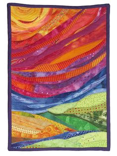 a quilted wall hanging with an abstract design on the front and back of it