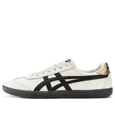 The Onitsuka Tiger Tokuten Shoes in the ‘White Black Gold’ colorway blend timeless style with modern flair. Crafted from sturdy leather, these sneakers feature a clean design in white, black, and cream white. The iconic Tiger stripes adorn the sides, while the reliable gum rubber sole ensures optimal grip. Whether you’re hitting the streets or adding a sporty touch to your outfit, these Tokuten shoes deliver comfort and versatility. A fusion of Japanese craftsmanship and contemporary fashion, they epitomize the Onitsuka Tiger brand spirit. The Onitsuka Tiger Tokuten Shoes in the ‘White Black Gold’ colorway (model number 1183B938-100) blend timeless style with modern flair. Crafted from sturdy leather, these sneakers feature a clean design in white, black, and cream white. The iconic Tiger Onitsuka Tiger Women Outfit, Nb Sneakers, Onitsuka Tiger Women, Black And Gold Outfit, Tiger Shoes, Timeless Shoes, Gold Outfit, Limited Edition Sneakers, Style Sportif