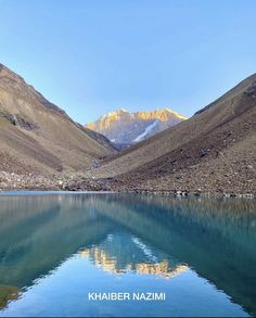 the mountains are reflected in the clear water