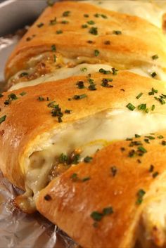 a cheesy bread with cheese and herbs on it