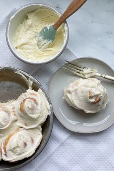 two bowls filled with food next to each other on top of a white table cloth