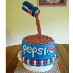 a cake that has been decorated with pepsi on it and the words pepsi is spelled in large letters