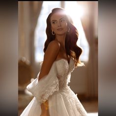 a woman in a white wedding dress posing for the camera