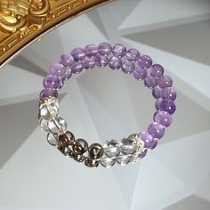 This elegant handmade bracelet features high-quality 6mm or 8mm beads made of natural lavender amethyst and clear quartz, known for their spiritual and healing properties. The amethyst promotes tranquility and spiritual growth, while clear quartz amplifies clarity and focus. What makes this bracelet truly special is the personalized alphabet beads, making it a meaningful gift for her, a family member, or a friend. Customize the size for a perfect fit, and let the personalized letters add a touch Lavender Crystal Bracelet With 8mm Beads As Gift, Lavender Amethyst Crystal Bracelet As Gift, Silver Amethyst Crystal Bracelet With 8mm Beads, Silver Amethyst Bracelet With 8mm Beads, Spiritual Purple Stackable Bracelets, Spiritual Purple Stackable Bracelet, Family Bracelet, Girly Bracelets, Meaningful Gifts For Her