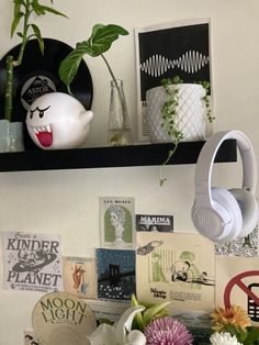 there are flowers and headphones on the shelf