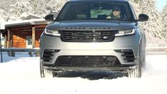 a range rover is driving through the snow