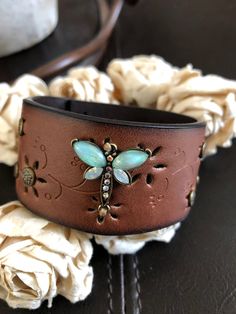 "🔶🔶Orders are shipping out 1-2 days later than normal. Thank you for your patience Dragonfly cuff bracelet Brown 1 1/4 inch distressed die-cut vegan leather strap has been adorned with an antiqued bronze dragonfly designed with glass opal colored wings and ab rhinestones secured with breaded waxed thread. Six textured antiqued bronze rivets have been added. An antiqued bronze snap has been placed to fit up to a 6 3/4\" wrist. I can add another snap for a smaller or larger fit but you need to c Antler Bracelet Jewelry, Handmade Leather Bracelets Ideas, Vintage Leather Bracelet For Gift, Vintage Leather Bracelet Gift, Vintage Adjustable Leather Bracelet For Gift, Vintage Adjustable Leather Bracelet Gift, Vintage Adjustable Leather Bracelet As Gift, Nickel-free Brown Leather Bracelet As Gift, Nickel-free Brown Leather Bracelet Gift