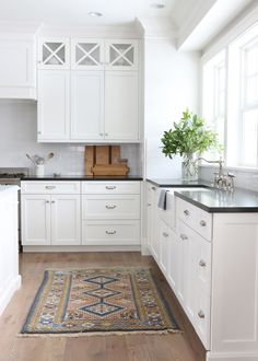 the kitchen is clean and ready for us to use it's white cabinetry