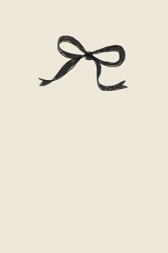 an image of a black ribbon tied in a bow on a white background with room for text