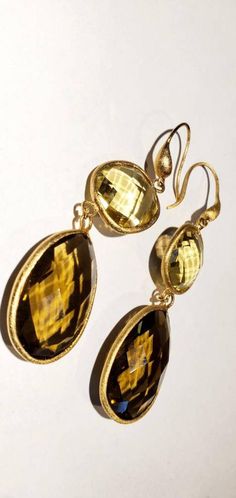 These vintage earrings are quite stunning and just what you need for special occasions. They feature faceted round and teardrop shaped smoky and yellow quartz in gold settings that catch the light just perfectly. They dangle from gold-toned ear wires. From the top of the wire to the bottom of the pearl, they measure 3 inches. These earrings are in very good vintage condition. Thanks for visiting my vintage jewelry store! Back to my shop here: https://www.etsy.com/shop/RemembrancesofYours Elegant Gold Teardrop Earrings With Gemstone, Gold Faceted Citrine Earrings, Gold Citrine Faceted Earrings, Gold Briolette Teardrop Earrings For Wedding, Elegant Gold Citrine Earrings, Gold Citrine Drop Jewelry, Gold Drop Earrings With Faceted Details, Gold Teardrop Gemstone Earrings For Wedding, Gold Faceted Drop Earrings