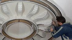 a man standing next to a large metal object