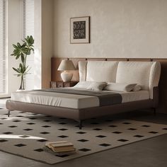 a large bed sitting on top of a rug next to a table with a lamp