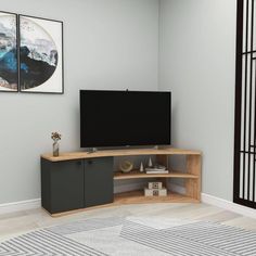 a flat screen tv sitting on top of a wooden entertainment center