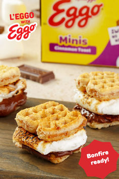 eggo waffle sandwiches with chocolate syrup and ice cream are on a cutting board