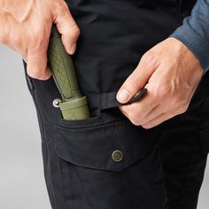 a man holding a knife in his pocket