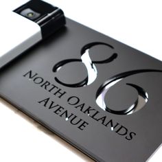 the north oakland avenue sign is black and silver