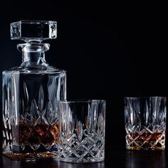 three glasses and a decanter on a table