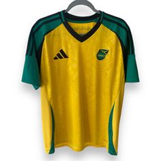 a yellow and green soccer jersey hanging on a hanger