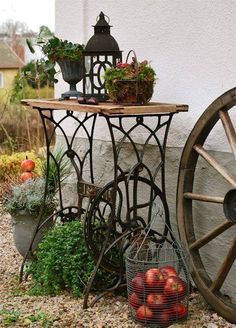 an old fashioned table with flowers and plants on it