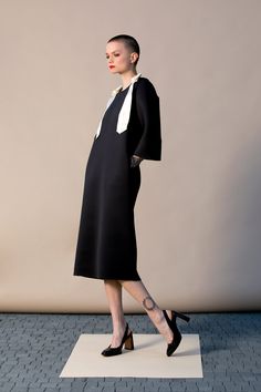 "With this beautiful Minimalist Dress we introduce our fashion for Spring 2019 ! This stylish black dress is cut in the the brand's most recognizable silhouette - the laid-back approach to elegance. The design has straight, elegant silhouette - it is our go-to for effortless, easy-to-wear pieces. Wear your occasion dress with sandals, high heels, ballerinas. ITEM DETAILS: - straight line - side pockets - shoulder bow decorations - custom orders: yes - color: black and creamy COMPOSITION AND CARE Black A-line Dress For Office Wear, Sheath Dress For Night Out, Office Lady Style, Modern Black Midi Dress For Party, Modern Black Mini Dress For Workwear, Black Office Lady Midi Dress For Office Wear, Black Sheath Office Dresses, Office Lady Black Midi Dress For Work, Black Midi Dress For Office Wear, Black Knee-length Midi Dress For Office