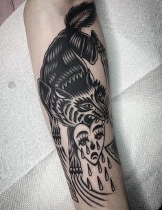 a woman's arm with a black and white tattoo on it