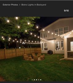 an outdoor patio with string lights strung across the fence and around the back yard area