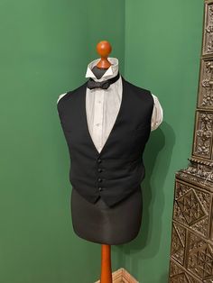 A classic waistcoat from around 1900s / 1910s. The waistcoat is in perfect condition. It should only be taken to the dry cleaner once. Dimensions: Chest: 49 cm Waist: 47 cm Shoulders: 38 cm Back: 47 cm Measurements are taken plain from left to right. Shirt, collar and bow tie are not included. Sold, as always, to the exclusion of any guarantee or withdrawal - since private. All information is made to the best of my knowledge. Elegant Wedding Vest With Buttons, Elegant Formal Vest With Buttons, Vintage Fitted Sleeveless Outerwear, Fitted Sleeveless Vintage Outerwear, Formal Tuxedo Style Sleeveless Vest, Formal Tuxedo Style Vest, Sleeveless Tuxedo Vest For Formal Events, Classic Fitted Black Nehru Jacket, Classic Sleeveless Vest For Formal Occasions