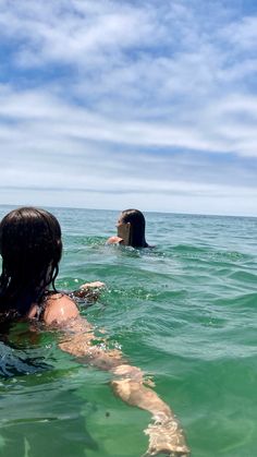 two people are swimming in the ocean together