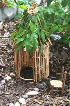 a bird house made out of sticks and leaves