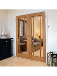 a living room with mirrored doors and furniture