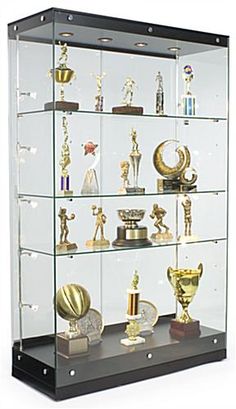 a glass display case filled with lots of trophies