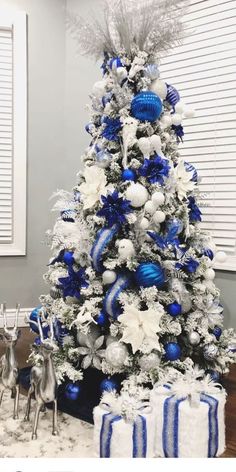 a blue and white christmas tree with silver ornaments