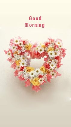 a heart shaped wreath with daisies and roses in the shape of a heart good morning