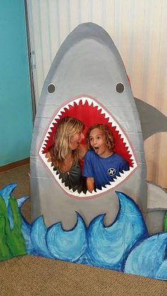 a woman and child are in a fake shark