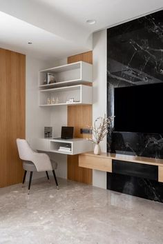 a modern home office with marble and wood accents, built - in shelving units