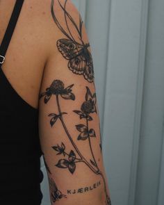 a woman with a butterfly tattoo on her arm