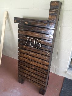 a number sign made out of wooden pallets