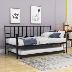 a black metal bed frame with white pillows