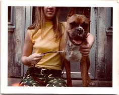 a woman holding a dog on a leash