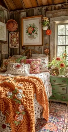 a bed in a room with lots of pillows and blankets on top of the bedspread