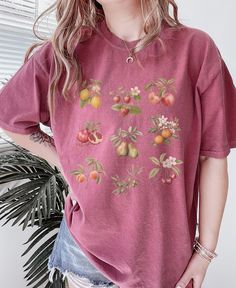 Cute Vintage Fruits Graphic Tee ✨ SIZING & MATERIALS: Printed on Unisex Comfort Colors c1717 garment-dyed t-shirt for a relaxed fit; the fabric brings extra coziness to your wardrobe while the relaxed fit makes it an excellent daily choice.  .: 100% ring-spun cotton .: Medium fabric (6.1 oz/yd² (206.8 g/m *Sizing down one size will give you a more fitted look* *Sticking with your normal size gives a nice relaxed look* *Sizing up 1-2 sizes gives an oversized look* Please compare measurements agai Vintage Relaxed Fit T-shirt With Plants Print, Relaxed Fit Graphic Tee With Plant Print, Pink Cotton Tops With Plant Print, Casual Pink T-shirt With Plant Print, Relaxed Fit Crew Neck Tops With Plant Print, Pink T-shirt With Plants Print In Relaxed Fit, Relaxed Cotton T-shirt With Plant Print, Casual Cotton T-shirt With Plant Print, Cotton T-shirt With Plant Print And Relaxed Fit